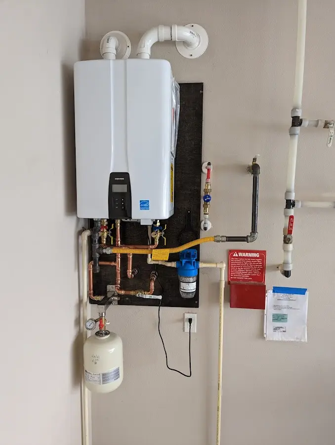 Professional plumber installing copper piping in a Franklin home